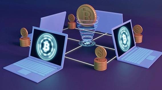 Four computers with the Bitcoin logo displayed on each of them, alongside some coins.