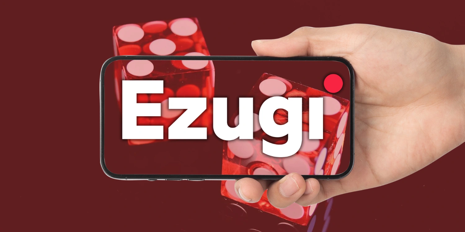 Ezugi live casino logo displayed on a smartphone held by a hand, with red dice in the background.
