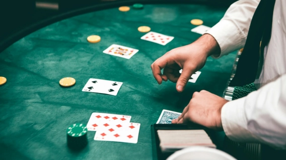 A dealer handing out the cards at a blackjack table