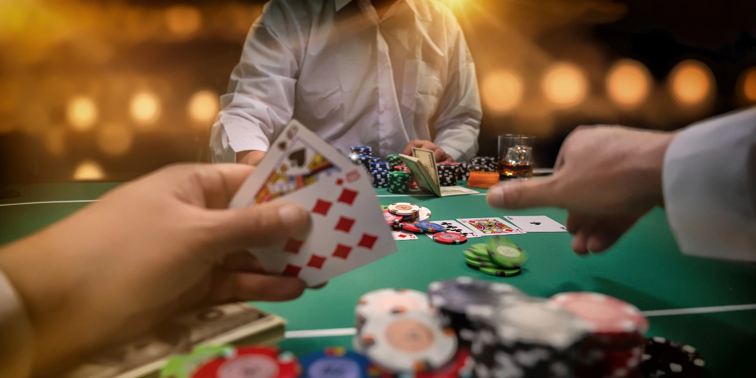 Players at a poker table, engaging in a game, with chips and cards on the table.